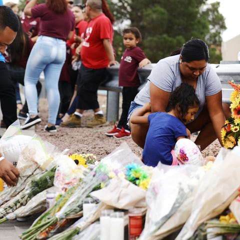 People leave flowers outside scene of shooting in...