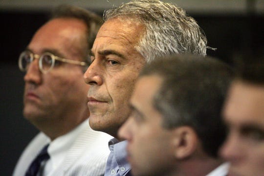 FILE - In this July 30, 2008, file photo, Jeffrey Epstein, center, appears in court in West Palm Beach, Fla.  Newly released court documents show that Epstein repeatedly declined to answer questions about sex abuse as part of a lawsuit. A partial transcript of the September 2016 deposition was included in hundreds of pages of documents placed in a public file Friday, Aug. 9, 2019 by a federal appeals court in New York. Epstein has pleaded not guilty to sex trafficking charges after his July 6 arrest.  (Uma Sanghvi/Palm Beach Post via AP, File) ORG XMIT: FLPAP127