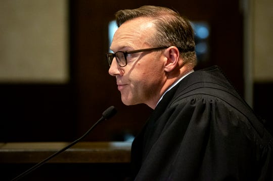 Judge Thad Balkman reads a summary of his decision in the opioid trial at the Cleveland County Courthouse in Norman, Okla., Monday, Aug. 26, 2019. Balkman ruled in favor of the state of Oklahoma and ordered Johnson and Johnson to pay $572 million to a plan to abate the opioid crisis.