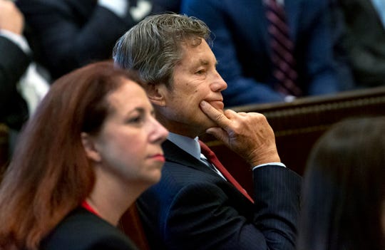 Defense attorney Larry Ottaway, right, listens as Judge Thad Balkman reads a summary of his decision in the opioid trial at the Cleveland County Courthouse in Norman, Okla., Monday, Aug. 26, 2019. Balkman ruled in favor of the state of Oklahoma and ordered Johnson and Johnson to pay $572 million to a plan to abate the opioid crisis.