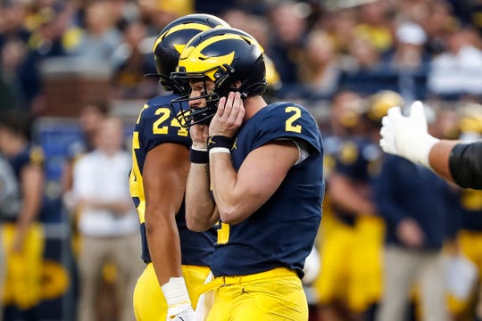 Michigan quarterback Shea Patterson reacts after fumbling during the first half against Middle Tennessee State at Michigan Stadium in Ann Arbor, Saturday, August 31, 2019.