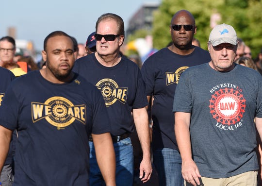 UAW President Gary Jones, second from left, whose home was raided by federal agents Wednesday as part of a corruption probe, walked with UAW members during the first part of the annual Labor Day parade in downtown Detroit, Sept. 2, 2019.