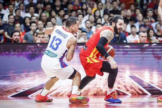 Ricky Rubio looks to get past Angel Rodriguez in Tuesday's FIBA World Cup.