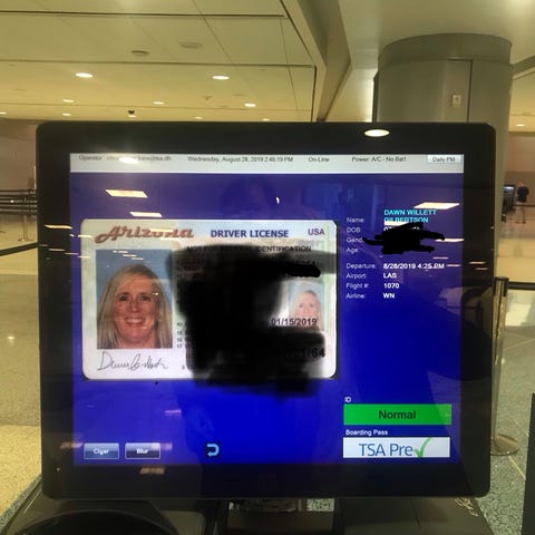 Travelers going through a new security checkpoint 