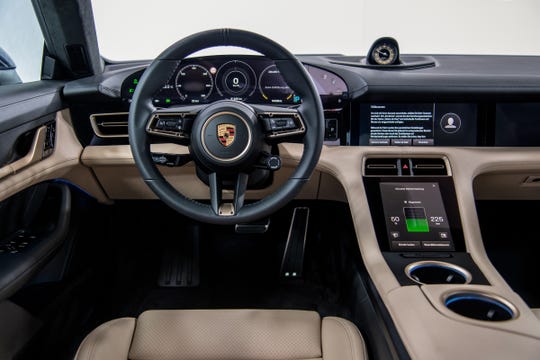 The interior of the Porsche Taycan electric car is nearly devoid of buttons and knobs.