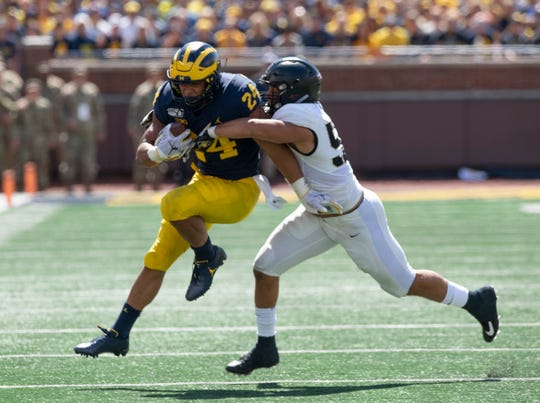 Michigan running back Zach Charbonnet picks up a first down in the second quarter.