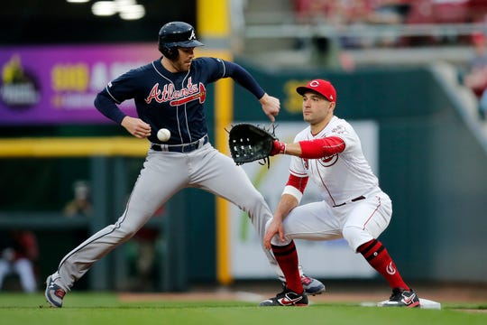 Atlanta Braves first baseman Freddie Freeman (5) steps back to first against Cincinnati Reds first baseman Joey Votto (19) on pick off attempt in the third inning of the MLB National League game between the Cincinnati Reds and the Atlanta Braves at Great American Ball Park in downtown Cincinnati on Wednesday, April 24, 2019