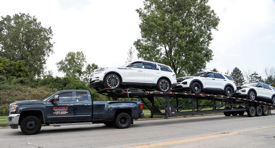 Two Ford Explorers and one Lincoln Aviator are seen on a car hauler on Gibraltar Road near Ford's Flat Rock Assembly Plant in Flat Rock, Wednesday, Sept. 11, 2019. They were taken there from Chicago to identify and fix manufacturing problems during the launch.