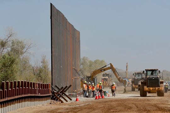 Government contractors erect a section of Pentagon-funded border wall along the Colorado River, Tuesday, Sept. 10, 2019 in Yuma, Ariz.