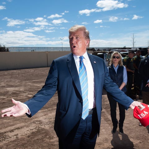 President Donald Trump tours the border wall betwe