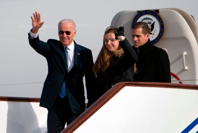 In this file photo taken Dec. 3, 2013, then-VP Joe Biden waves from AF Two <br>w/ granddaughter, Finnegan and son Hunter  upon their official arrival in Beijing