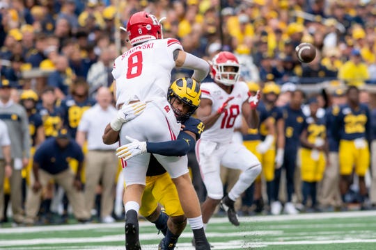 Michigan linebacker Cameron McGrone grabs ahold of Rutgers quarterback Artur Sitkowski during a play in the first quarter.