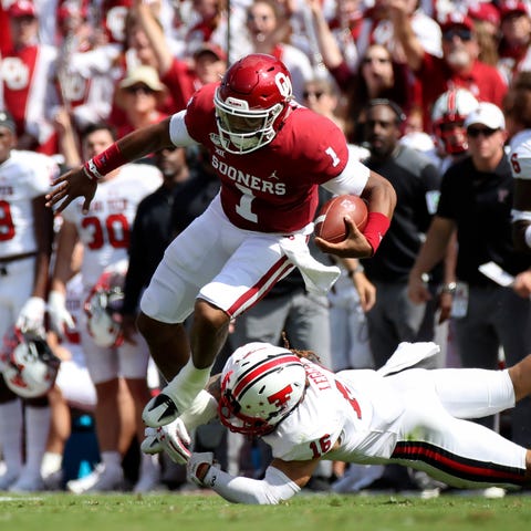 Oklahoma quarterback Jalen Hurts jumps over Texas 