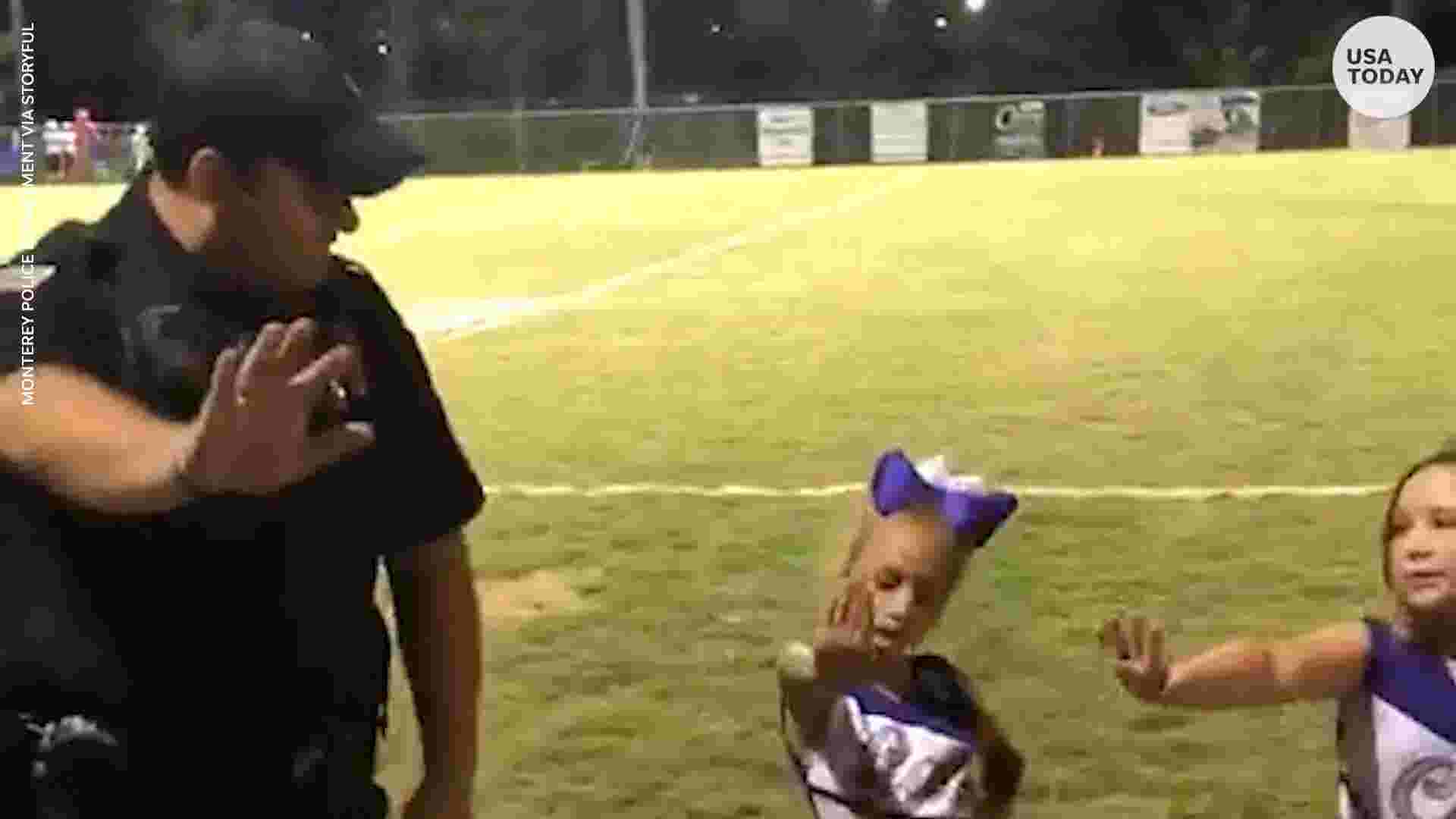 Tiny cheerleaders teach police officer cheer routine during home game picture pic
