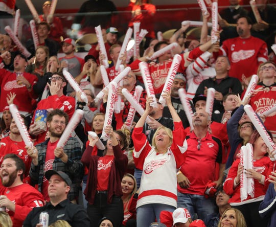 Red Wings fans celebrate a goal against the Stars during the second period Sunday at Little Caesars Arena.