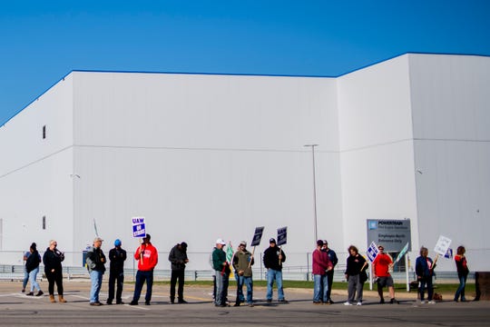 General Motors' Flint Assembly Plant employees line the street with picket signs during the nationwide UAW strike against General Motors.