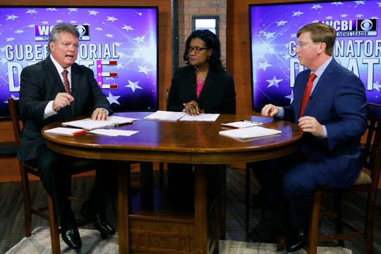 Democratic Attorney General Jim Hood, left, responds to a question while Republican Lt. Gov. Tate Reeves, left, and moderator and WCBI anchor Aundrea Self listen during the second televised gubernatorial debate in Columbus, Miss., Monday, Oct. 14, 2019. (AP Photo/Rogelio V. Solis, Pool)