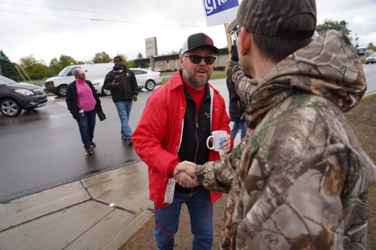 UAW Local 598 president Ryan Buchalski spreads the news to strikers outside General Motors Flint Assembly in Flint after it was announced GM and the UAW had reached a proposed tentative agreement on Wednesday, Oct. 16, 2019.