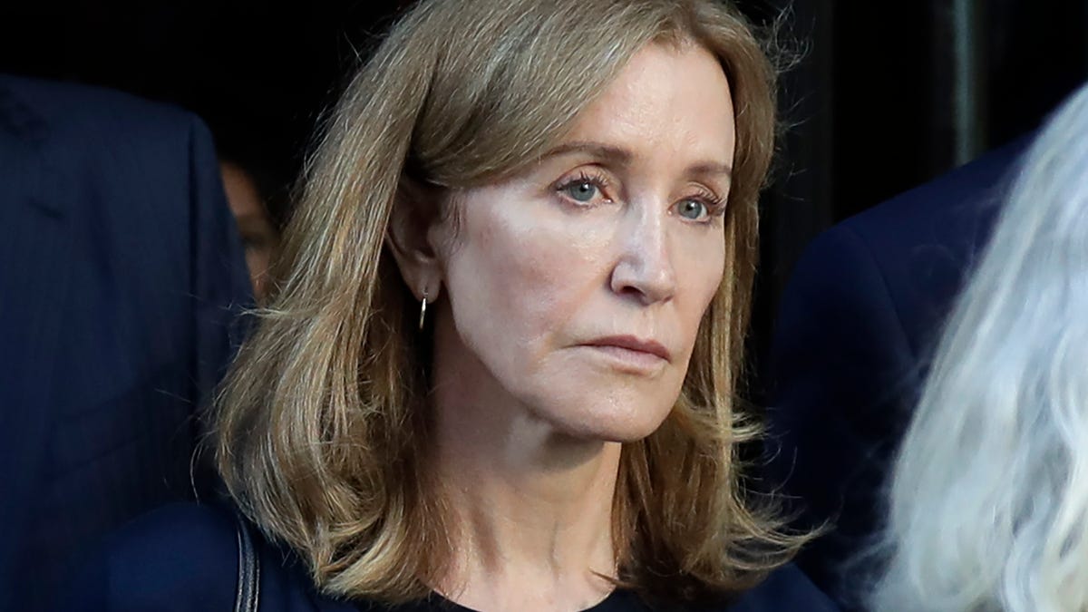 FILE - This Sept. 13, 2019 file photo shows actress Felicity Huffman leaving federal court after her sentencing in a nationwide college admissions bribery scandal in Boston.