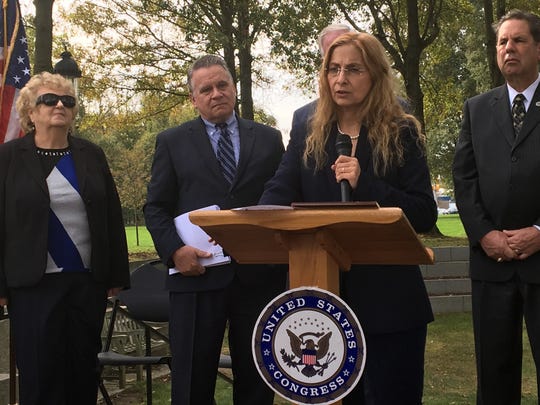 Marlboro's Jodie Dashore, a chronic Lyme disease survivor and a practitioner who treats others with the condition, speaks at Friday's press conference in Wall. At left are Wall resident Pat Smith, president of the Lyme Disease Association (far left) and Rep. Chris Smith (second from left).