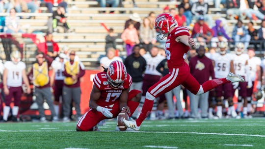 UL receiver/holder Bam Jackson, left, and kicker Stevie Artigue, shown here in a November game against Texas State, now are preparing for potential pro careers.
