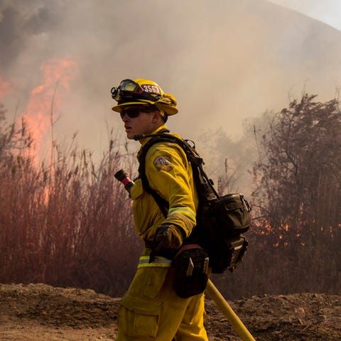 A CalFire firefighter works on the Maria fire spre