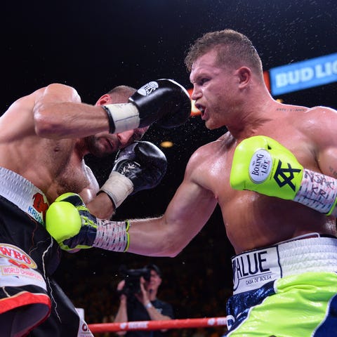 Canelo Alvarez punches Sergey Kovalev during their