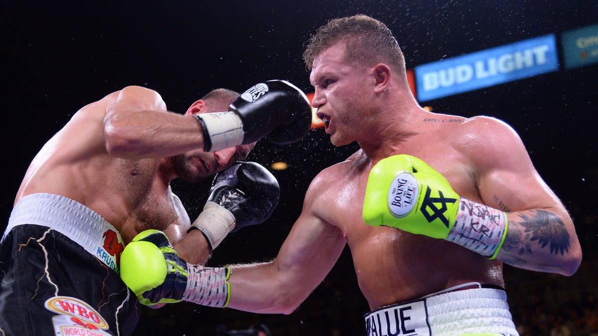 Canelo Alvarez punches Sergey Kovalev during their WBO light heavyweight title bout at MGM Grand Garden Arena.