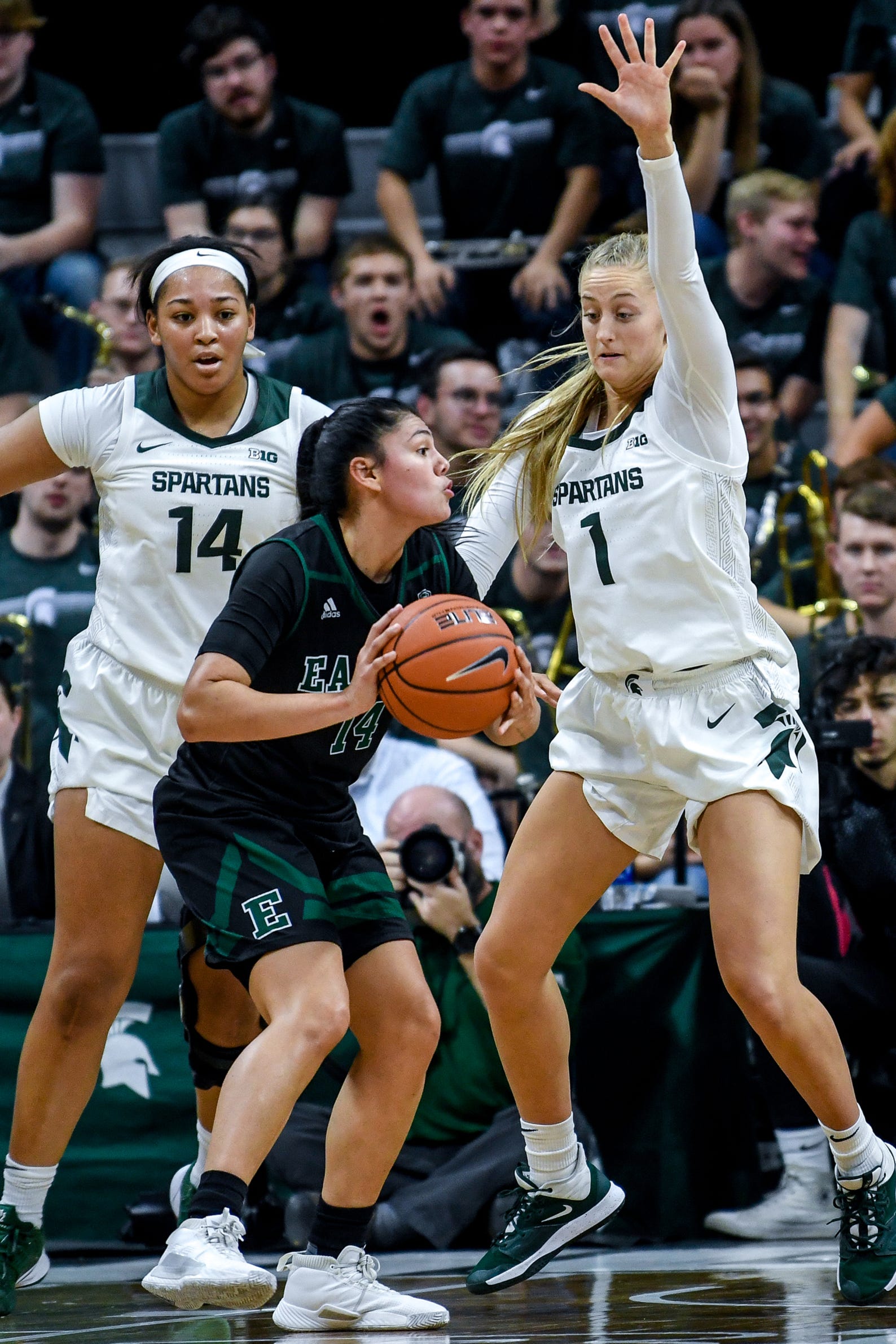 Michigan State's Taiyier Parks, left, and Tory Ozment, right, pressure Eastern Michigan's Natalia Pineda during the  fourth quarter on Tuesday, Nov. 5, 2019, at the Breslin Center in East Lansing.