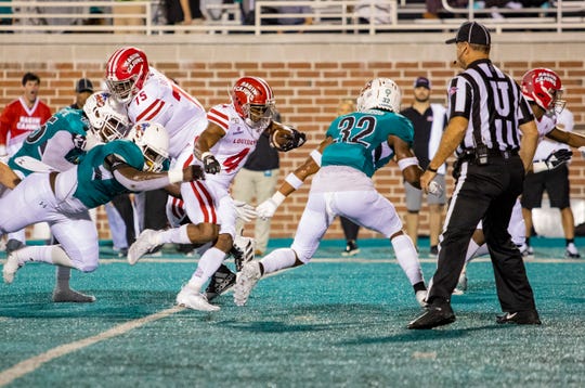 Tampa Bay Buccaneers draft choice Raymond Calais Jr. runs the ball for UL as Pittsburgh Steelers pick Kevin Dotson (75, left) blocks on the back side during a game last season at Coastal Carolina.