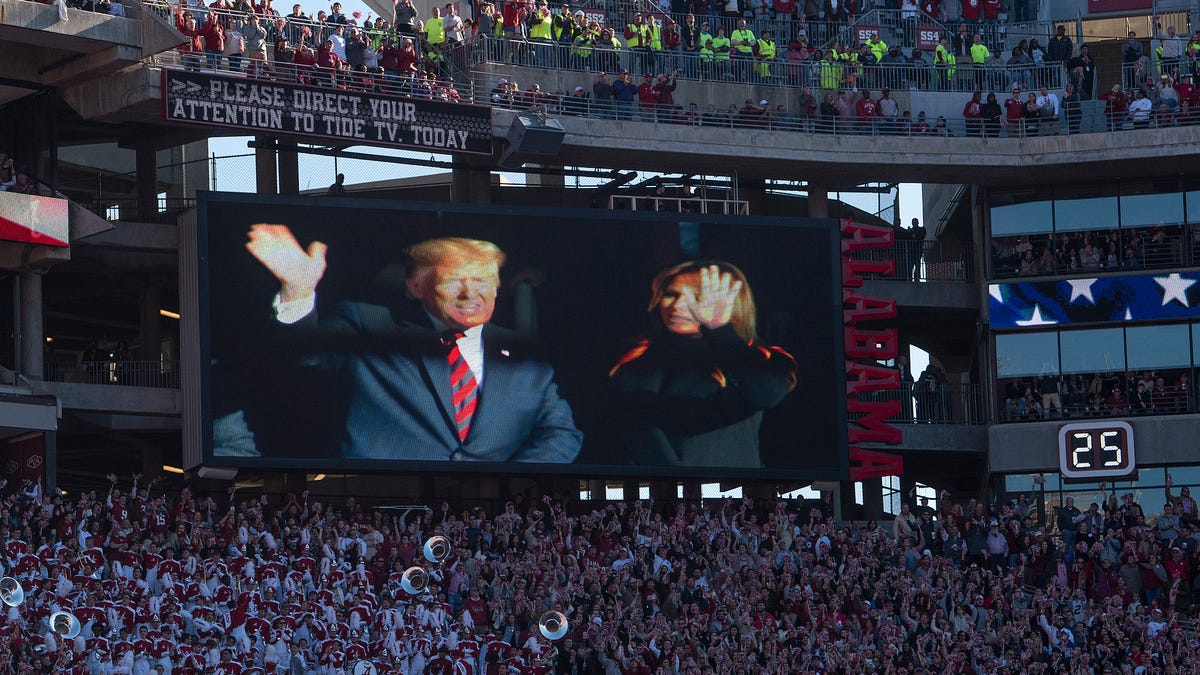 President Donald Trump and First Lady Melania Trump wave during the first quarter of the Alabama vs. LSU game  at Bryant-Denny Stadium in Tuscaloosa, Ala., on Saturday November 9, 2019.