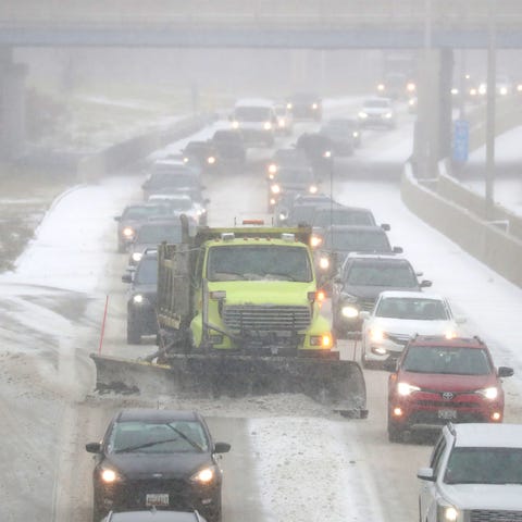 A Milwaukee County snow plow makes its way through