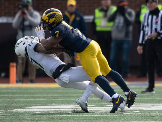 Michigan linebacker Khaleke Hudson clobbers Michigan State wide receiver Tre Mosley on an incomplete pass play in the second half earlier this season.