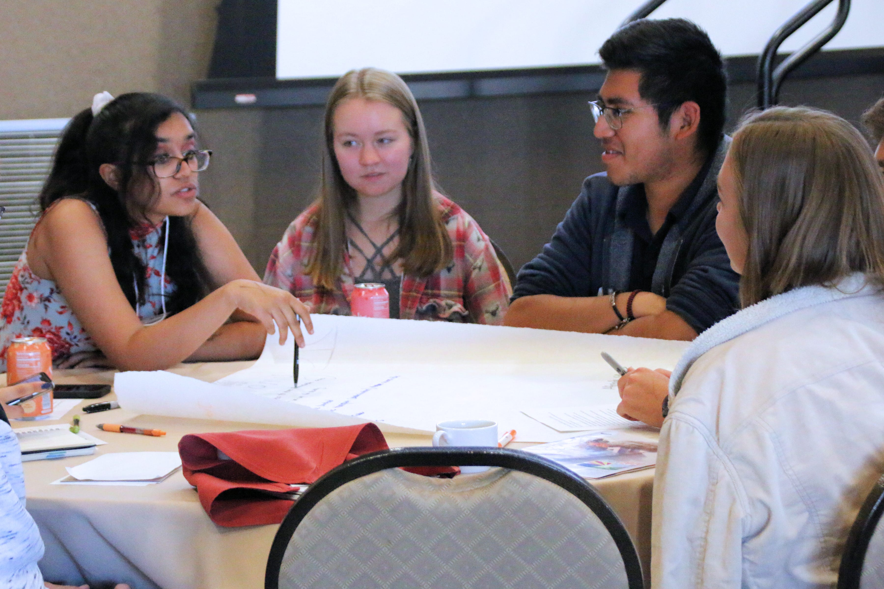Aditi Narayanan (left) discusses ideas for economic solutions to address climate change, along with Ryan Harrop (center) and Brian Mecinas (right) during the youth forum at the conference “Climate 2020: Seven Generations for Arizona” at Northern Arizona University in Flagstaff on Nov. 16, 2019.