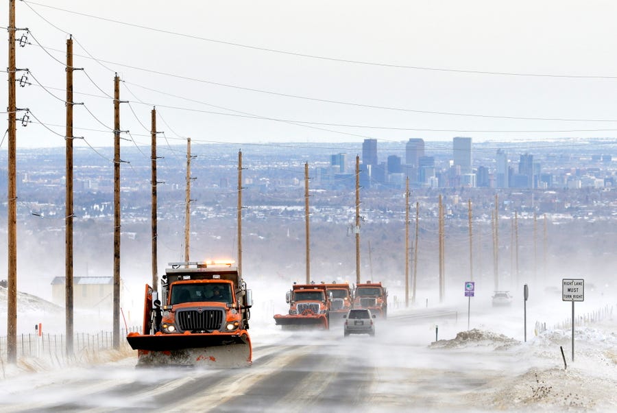 Snow plows remove snow from Colorado Highway 72, near Denver, Colorado on November 30,  2019, in an effort to keep the highways clear of blowing and drifting snow. Holiday snow storms left as much as two feet of snow in some parts of the Denver area. High winds and drifting snow forced highway officials to close many roads.