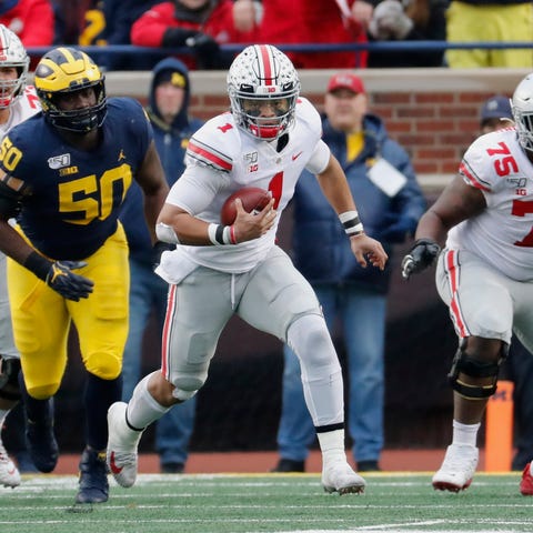 Ohio State quarterback Justin Fields runs for yard