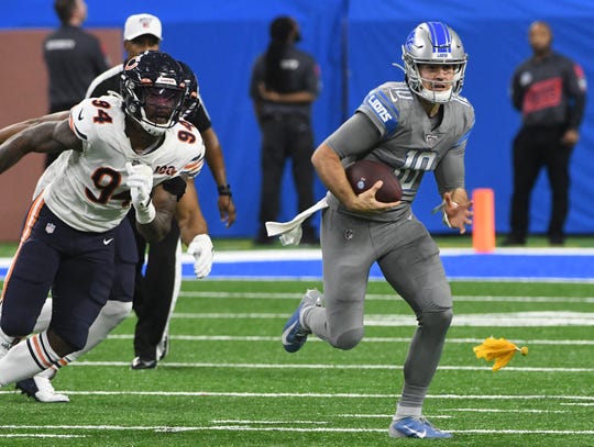 Lions quarterback David Blough breaks out of the pocket for a run as a penalty flag is thrown in last week's game against the Bears. The penalty was called on Detroit.