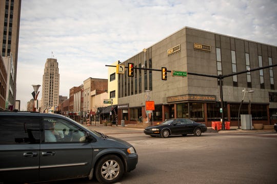 Traffic flows through downtown on the corner of Michigan Ave. and Capital Ave. on Friday, Dec. 13, 2019 in Battle Creek, Mich. Michigan Avenue reopened that morning for the first time since November 2018.