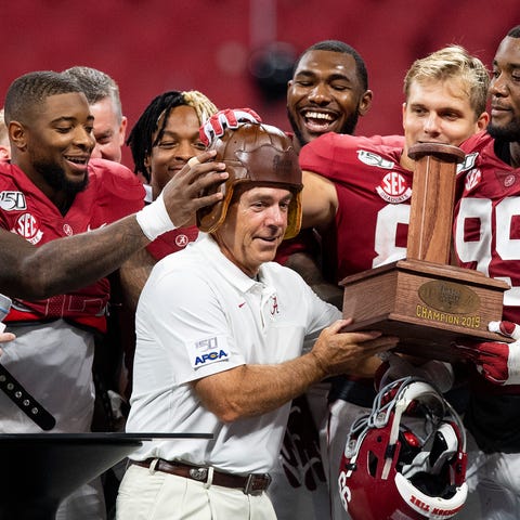 Players place the Old Leather Football Helmet Alab