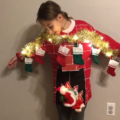 Santa slides down the chimney in mom's epic ugly Christmas sweater for  daughter