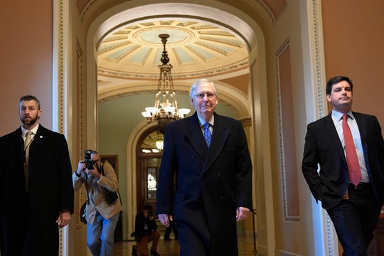 Senate Majority Leader Mitch McConnell walks to his office on Capitol Hill on Dec. 19, 2019.