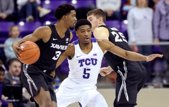 Dec 22, 2019; Fort Worth, Texas, USA;  Xavier Musketeers guard Quentin Goodin (3) dribbles as TCU Horned Frogs guard Jaire Grayer (5) defends during the first half at Ed and Rae Schollmaier Arena.