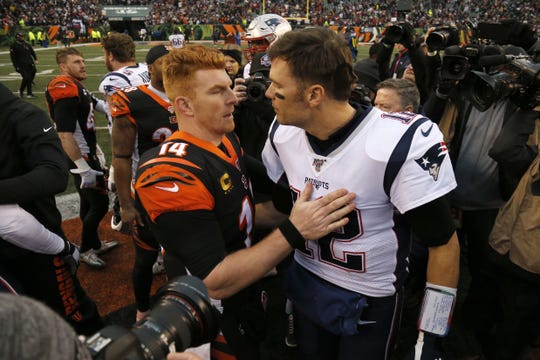 Andy Dalton (14) and New England Patriots quarterback Tom Brady (12) shake hands after the fourth quarter of the game between the Cincinnati Bengals and the New England Patriots on Sunday, Dec. 15, 2019.