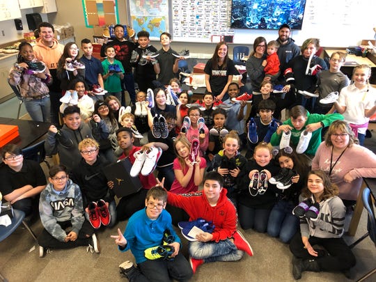 Sixth grade students at Lafayette Sunnyside Intermediate School pose with the new pair of shoes they received from New View Doors and Windows on Dec. 20, 2019. New View donated 47 pairs of shoes to the children.