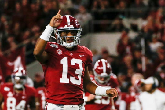 Alabama Crimson Tide quarterback Tua Tagovailoa (13) celebrates after a touchdown during the first half of an NCAA football game against the Tennessee Volunteers at Bryant-Denny Stadium.