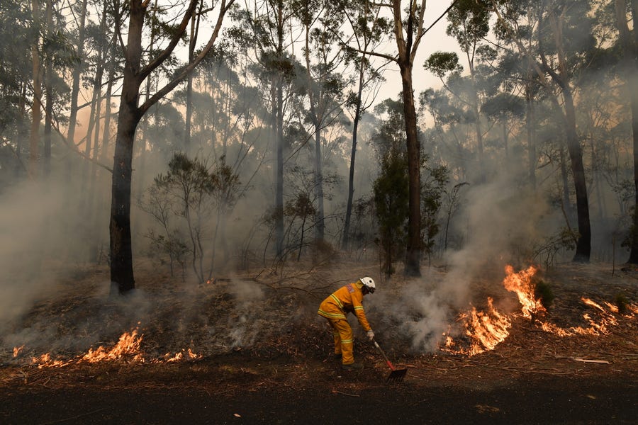 A firefighter works to contain a bushfire near Ulladulla, Australia, Jan. 5, 2020.