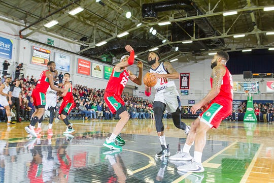 Michael Cobbins #20 of the Capital City Go-Go goes for a shot against Kaiser Gates #22 of the Maine Red Claws on Thursday, January 9, 2020 at the Portland Expo in Portland, Maine.
