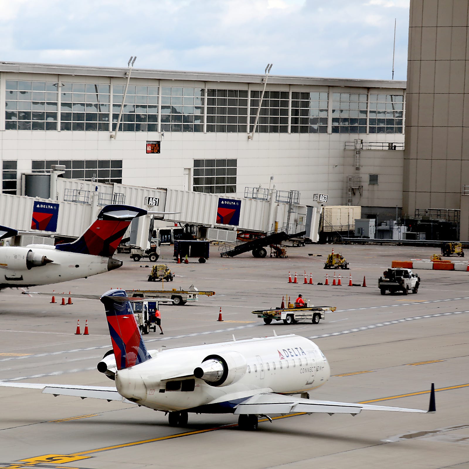 More than 7,000 Delta Air Lines employess in Michigan will receive a bonus check on Feb. 14 that adds up to roughly two months of pay. File: Delta Air Lines' planes line up to take off from McNamara terminal at the Detroit Metropolitan Airport in Romulus, Mich. on Sept. 26, 2018.