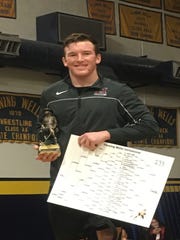 Chandler Hamilton wrestler Ryan Castillo holds trophy after winning first place in the 195-pound championship at the Flowing Wells Invitational