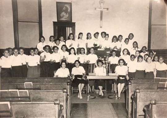 This photo of young girls holding candles up in a church has no date, but Annie Jones estimates it to be from the late 1950s. Jones is former YWCA Phyllis Wheatley Center executive director.